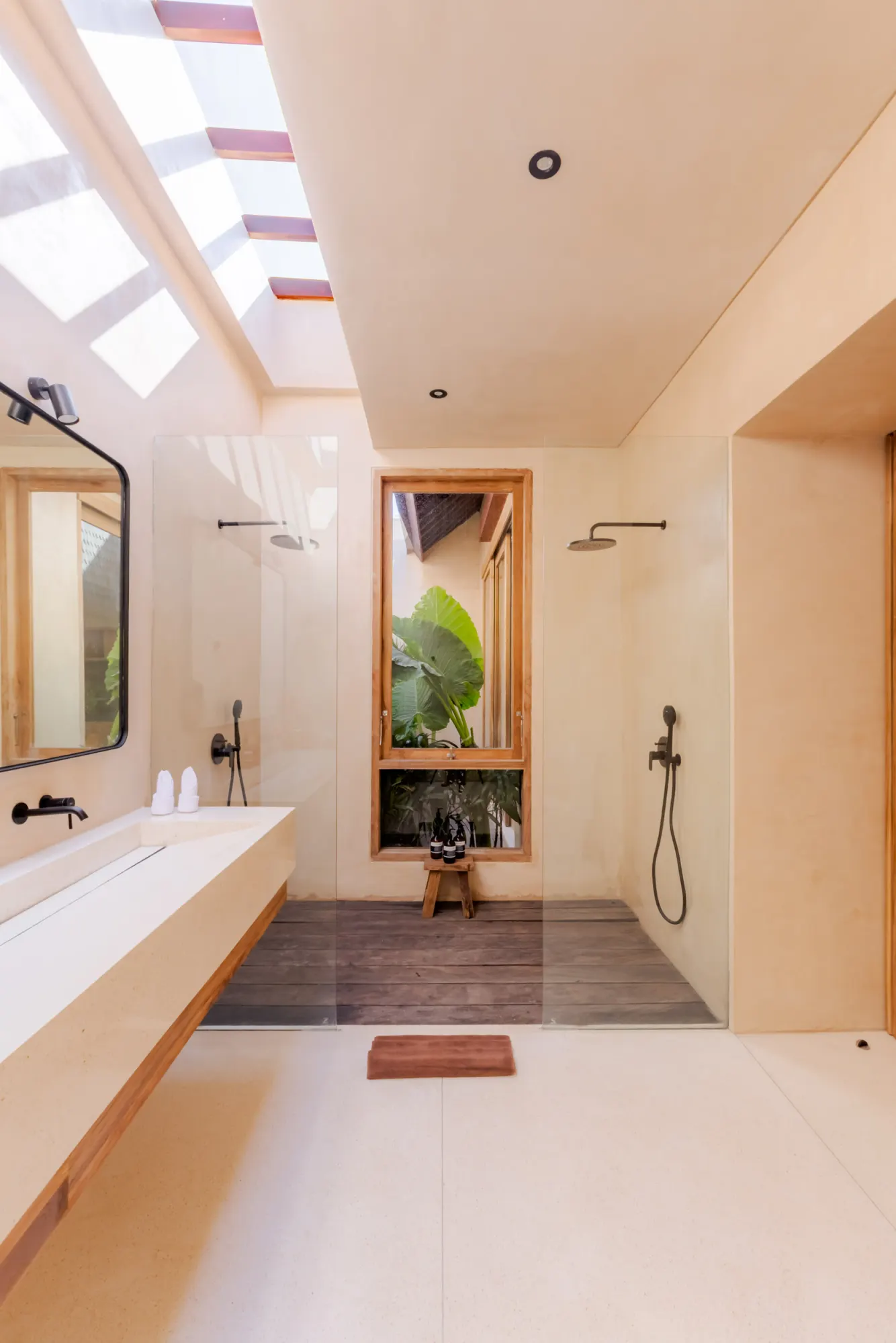 Spa-inspired bathroom with skylights and garden views through window