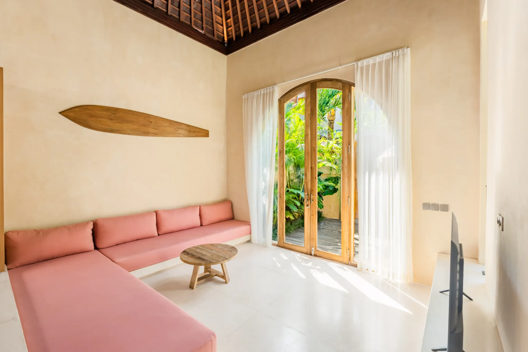 Minimalist living area with doorway to garden pavilion and courtyard