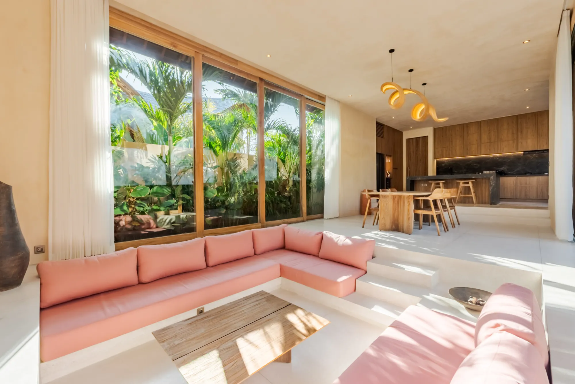 Open-plan living space with coral seating and garden views