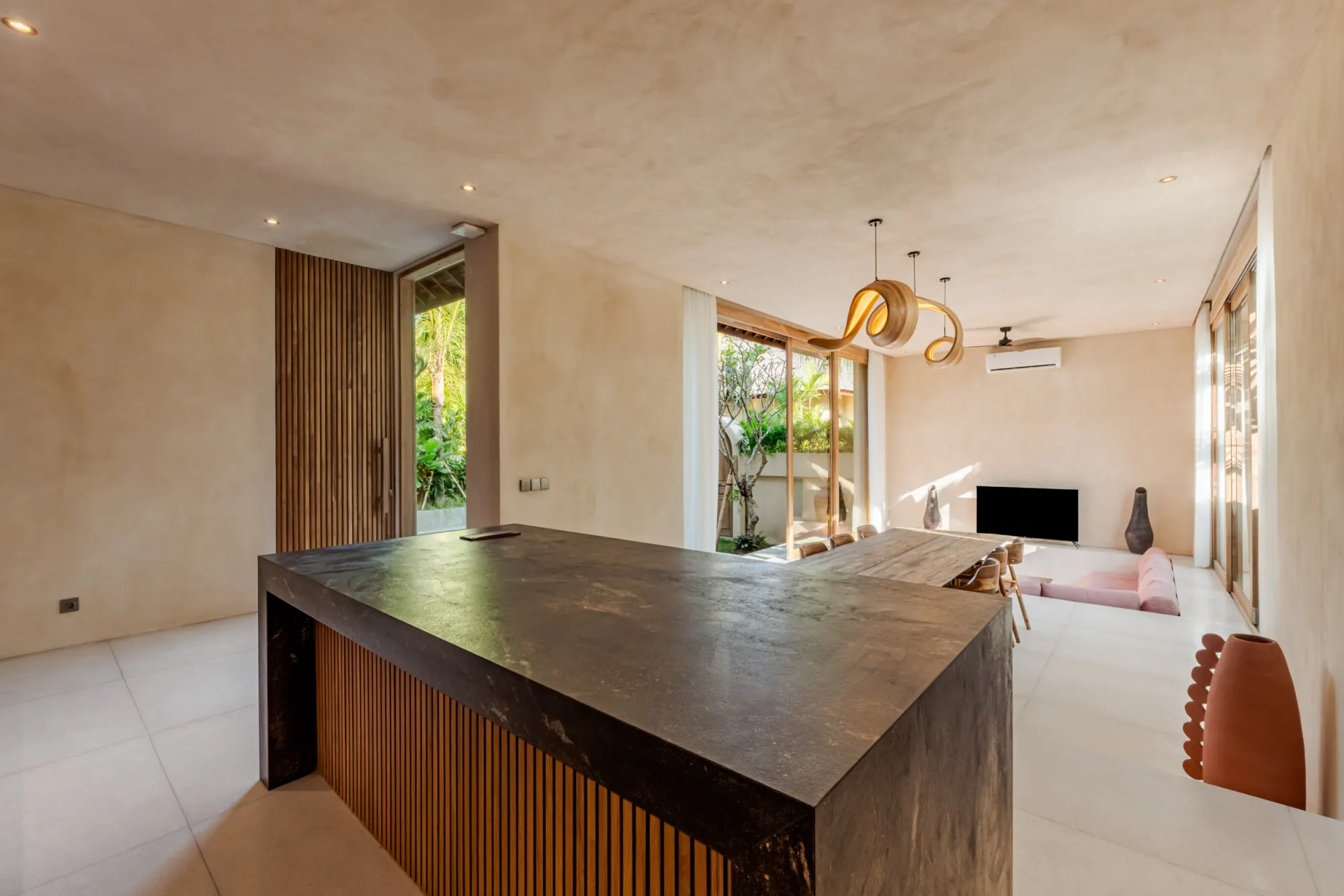 Contemporary kitchen with black marble backsplash and wood cabinetry
