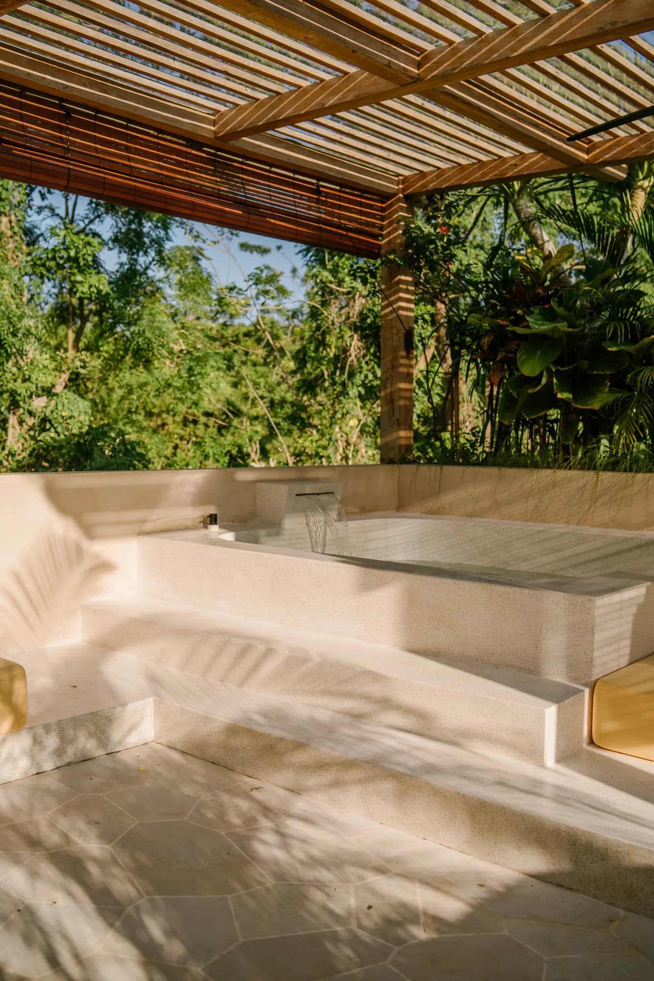 Outdoor stone spa pool with tropical canopy and lounge area