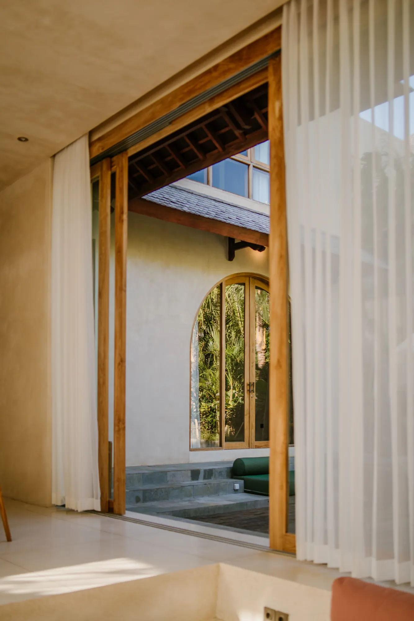 Open interior passage with views to tropical garden beyond