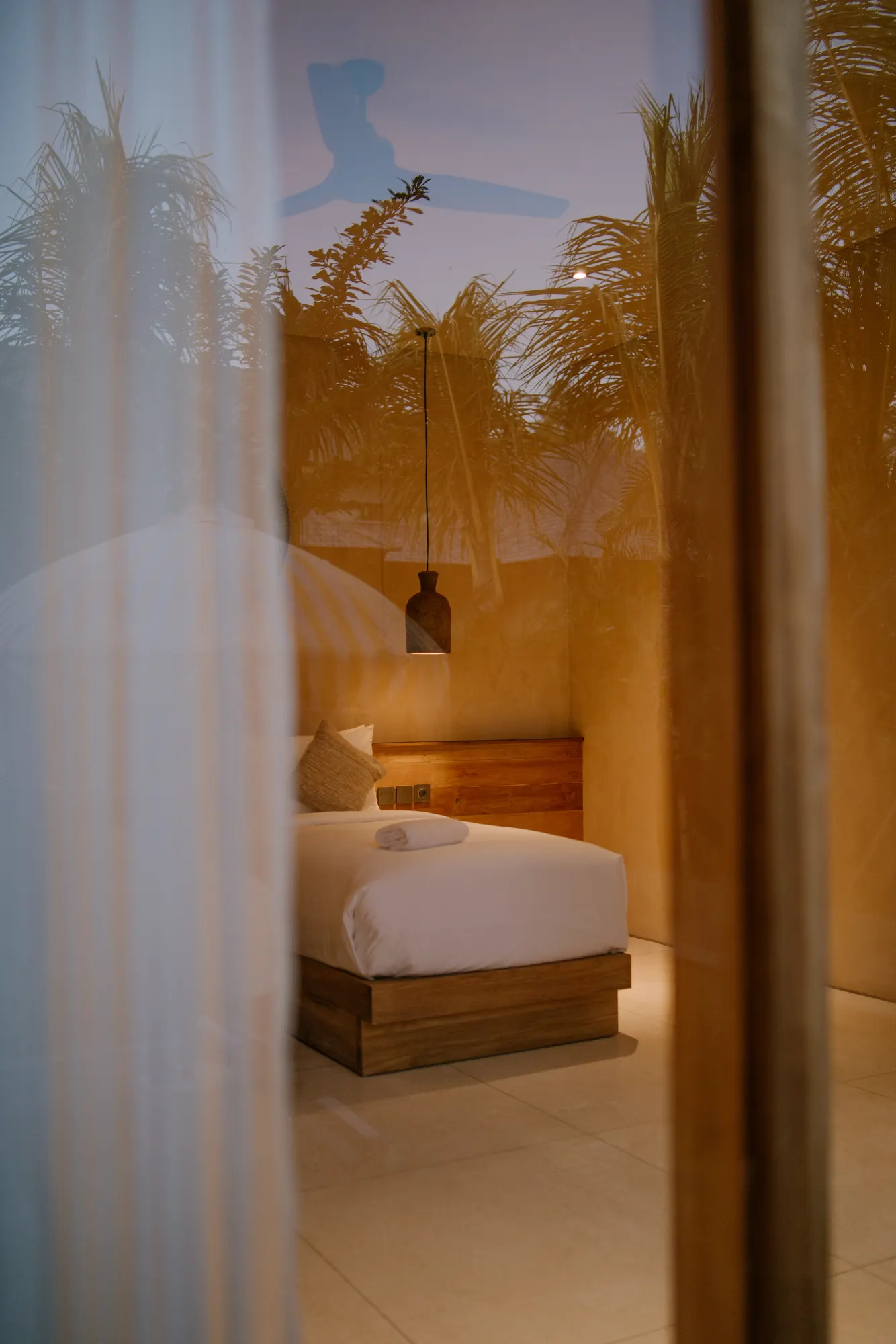 Bedroom with white sheets and ambient lighting