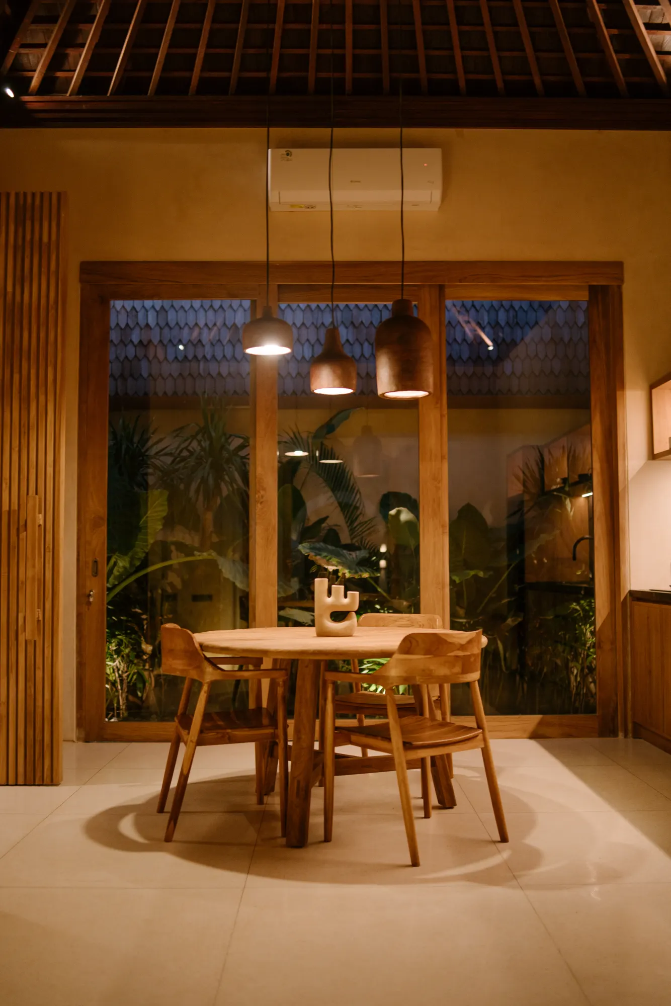 Dining area with round table and chairs at night