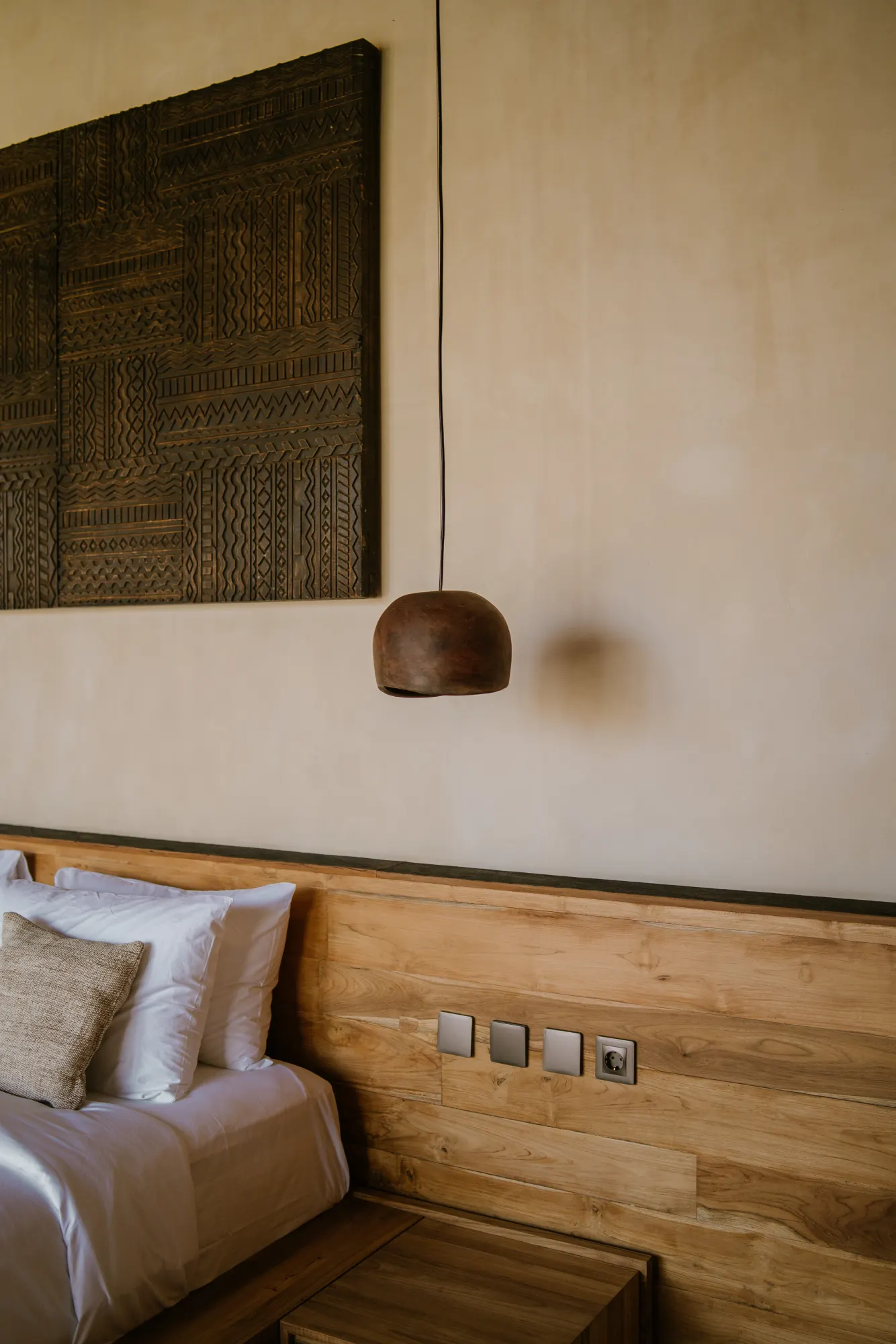 Serene bedroom nook with pendant light and shelving