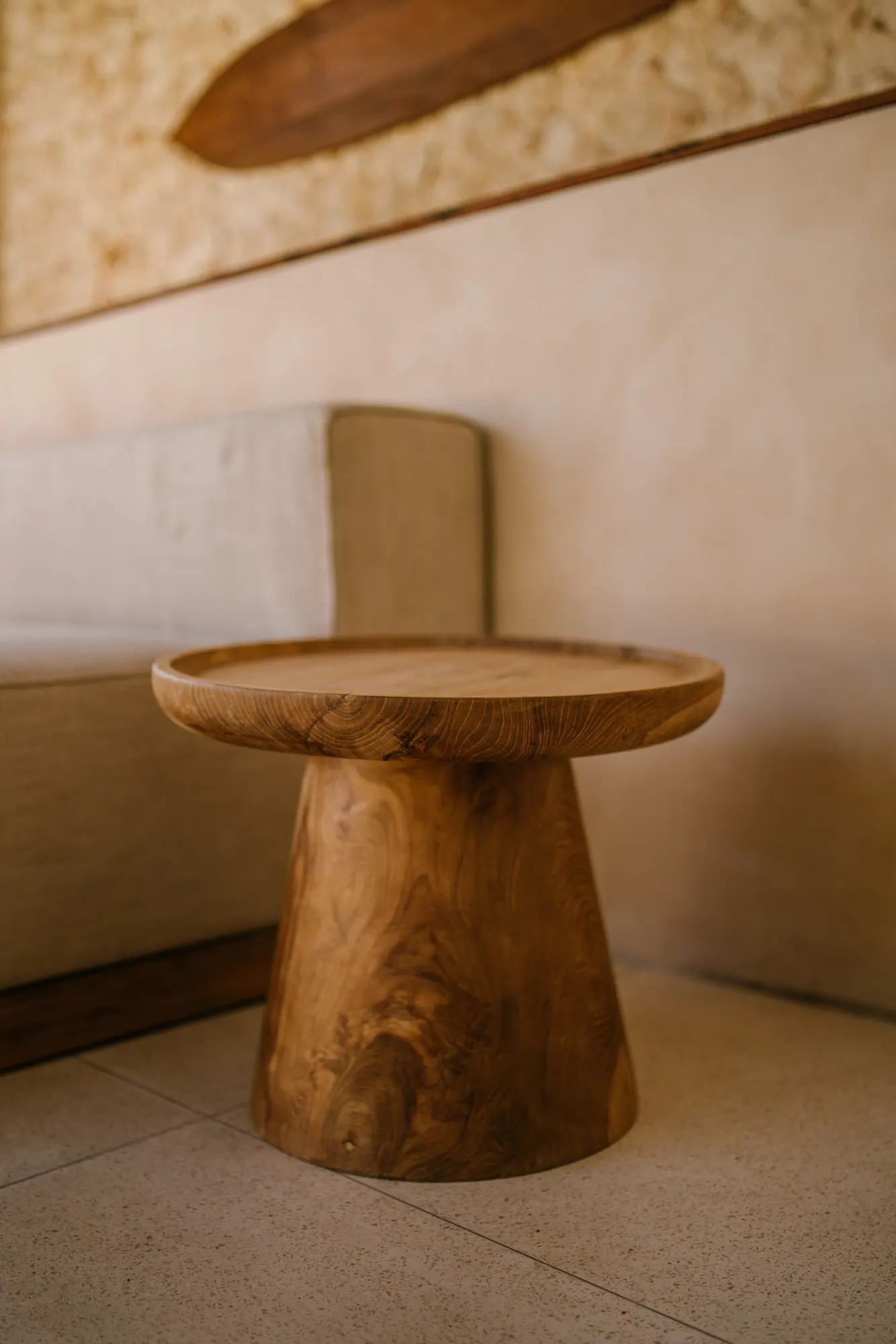 Wooden pedestal table in contemporary interior setting