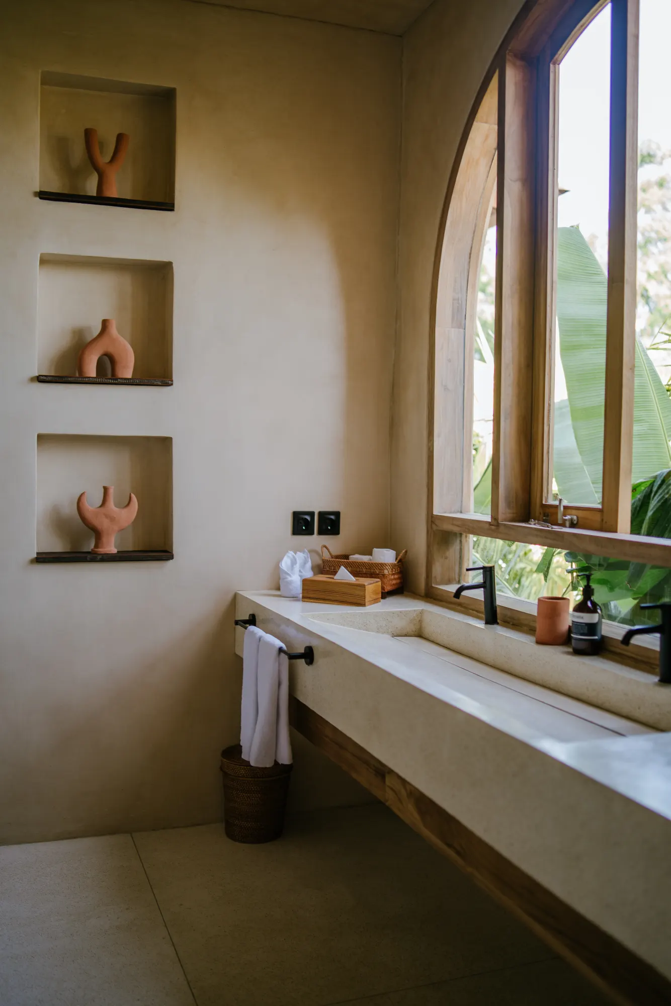 Minimalist bathroom with decorative shelves and brass accents