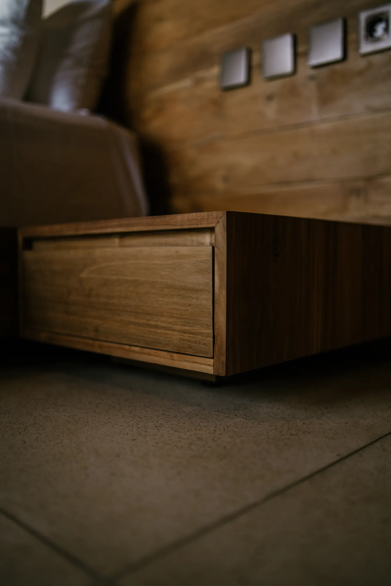 Side table next to bed with wooden elements