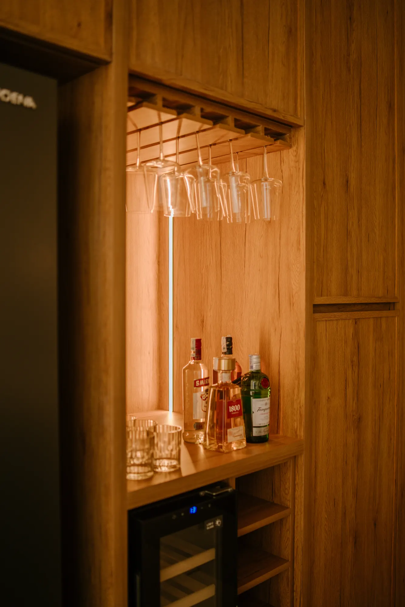 Liquor display cabinet with decorative hanging glasses