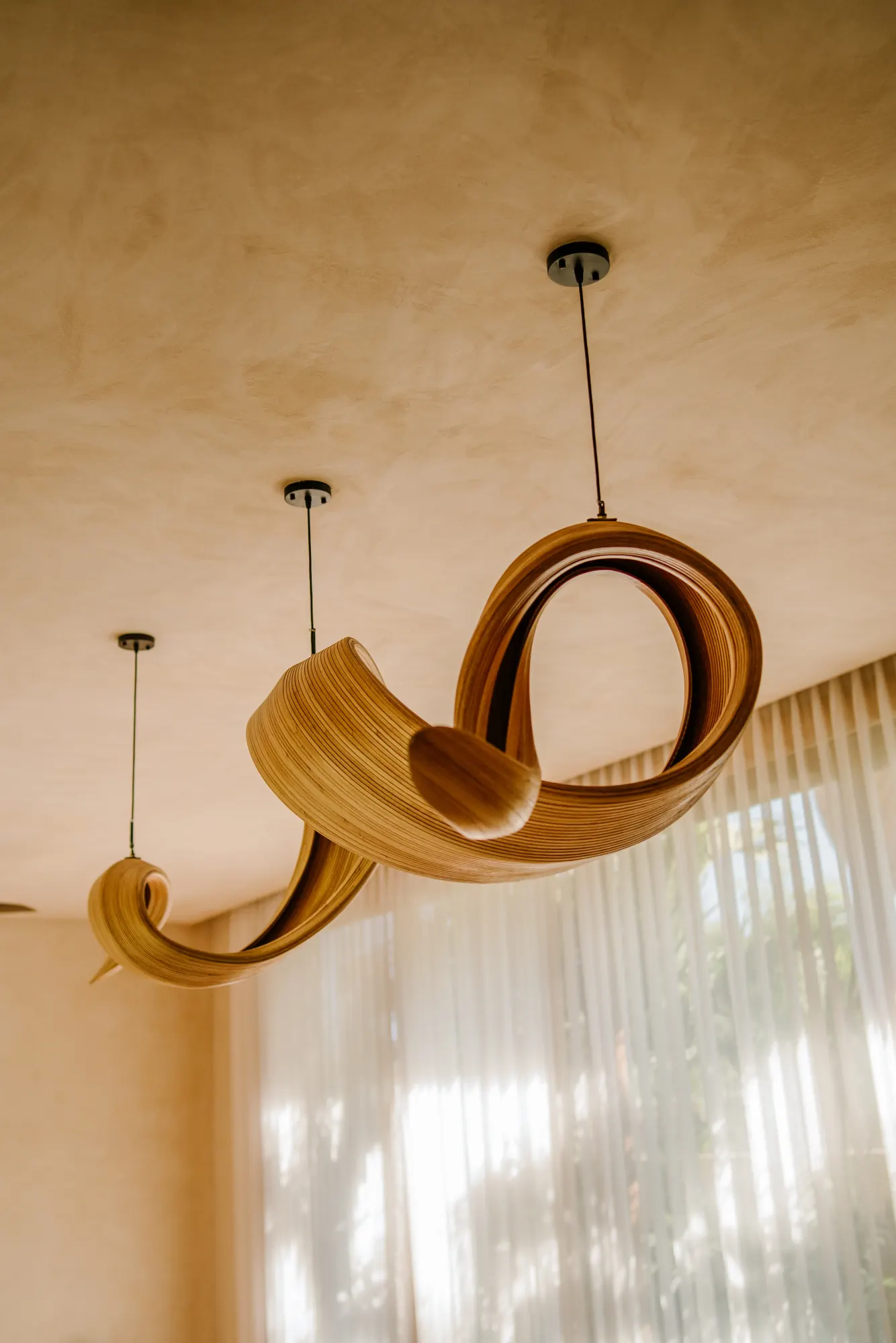 Orange sofa lounge with sculptural pendant lights