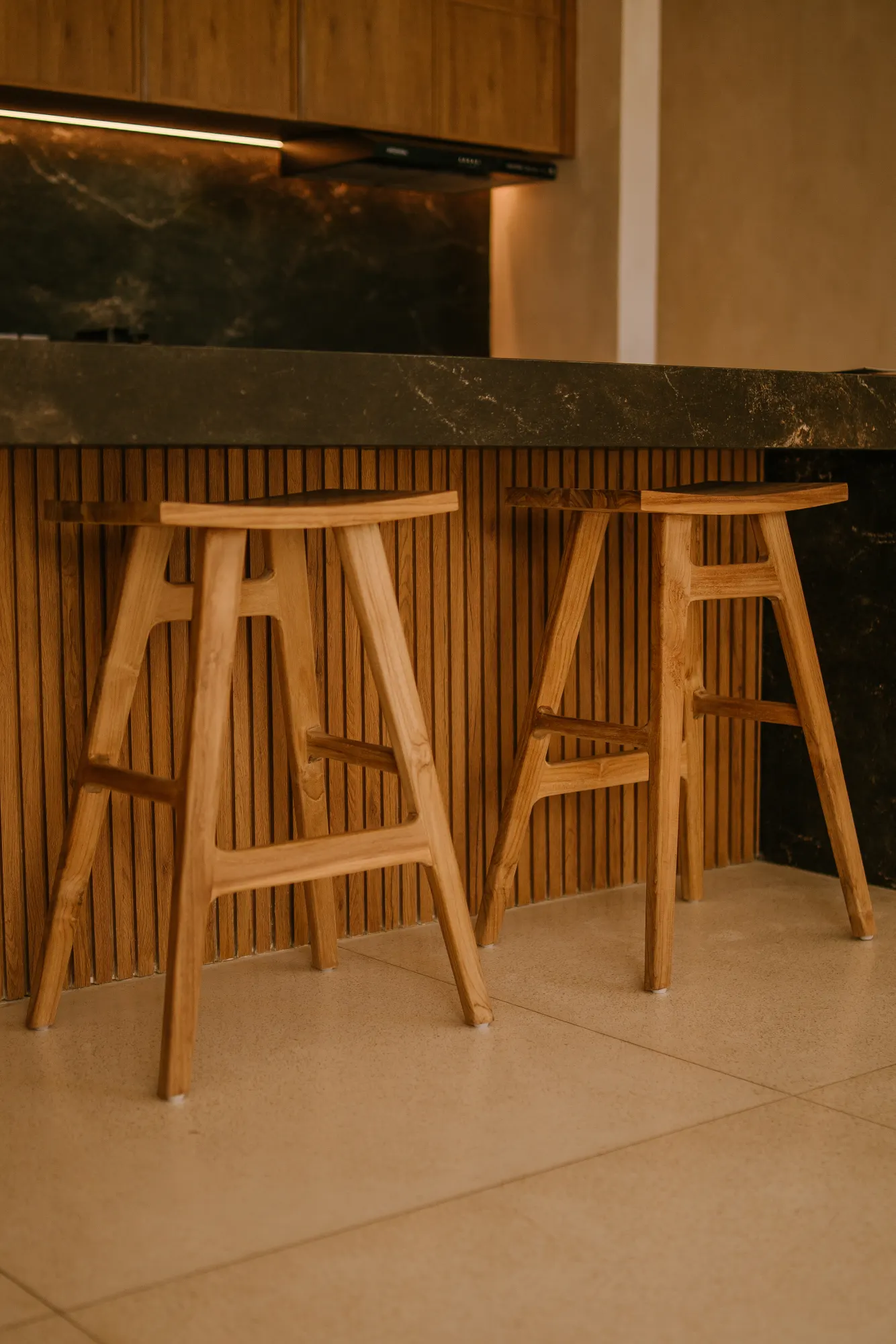 High bar seating with textured wooden panel backdrop