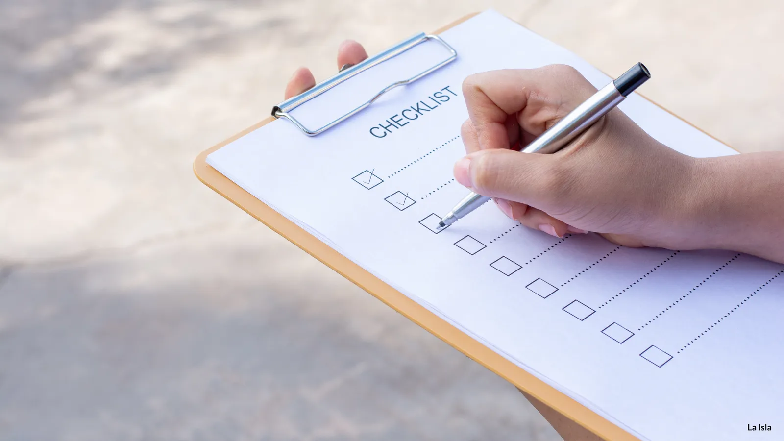 Ticking off a travel safety checklist on a clipboard