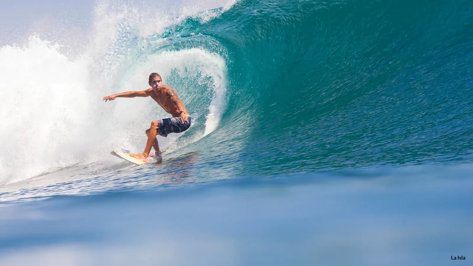 A surfer riding inside the barrel at Uluwatu, Bali